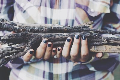 Midsection of woman holding sticks