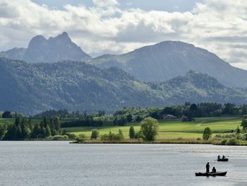 Scenic view of lake and mountains against sky