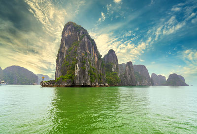 Scenic view of rock formation in sea against sky