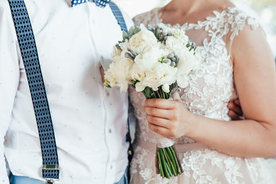 Midsection of couple standing during wedding