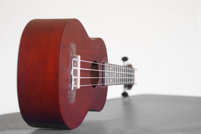 Close-up of guitar against white background