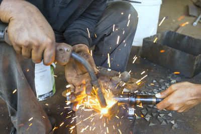 High angle view of man working on barbecue grill