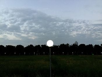 Scenic view of grassy field against sky