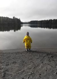 Rear view of boy in lake