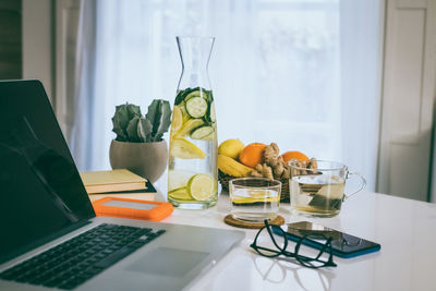 Healthy breakfast laptop and phone on table. natural meal and drink at work in remote office