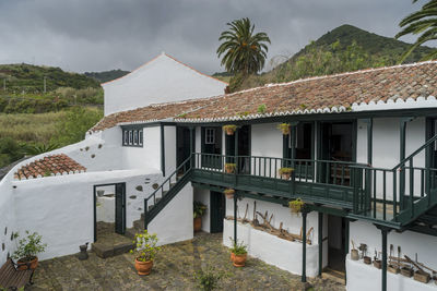 Houses by mountain against sky