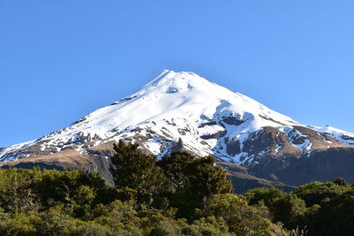 Scenic view of snowcapped mountains against clear blue sky