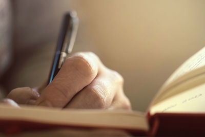 Close-up of hand holding book