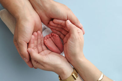 Cropped hand of person holding baby