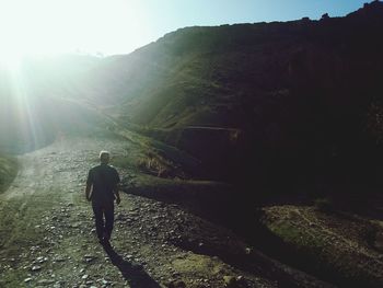 Rear view of man walking on mountain