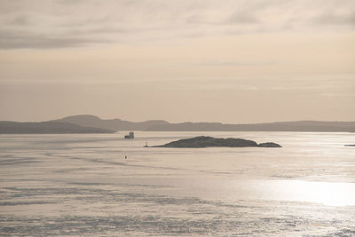 A ship sailing in a cold fjord in rhe winter
