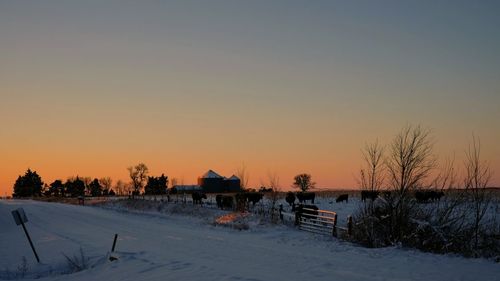 Scenic view of landscape against clear sky during winter