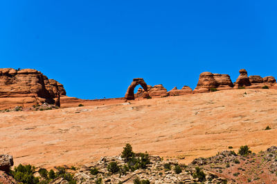 Rock formations on field against sky