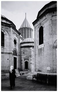 Rear view of woman standing outside temple