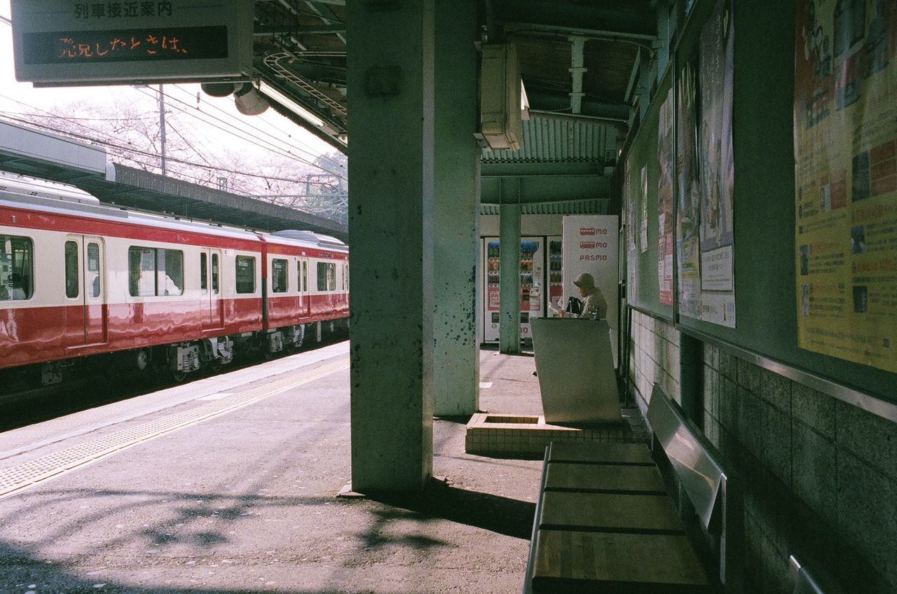 TRAIN ON RAILROAD STATION PLATFORM