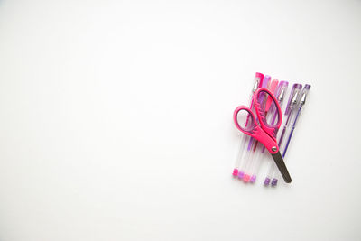 High angle view of colored pencils over white background