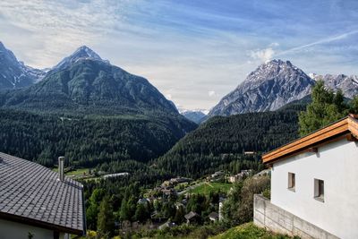 Houses and mountains against sky