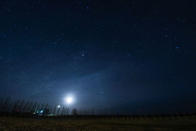 Scenic view of field against sky at night