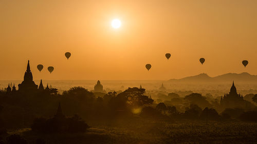 Hot air balloons against sky during sunset