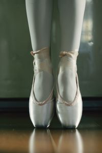 Low section of ballerina tiptoeing