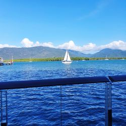 Sailboat sailing on sea against blue sky