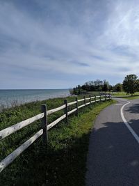 Road by sea against sky