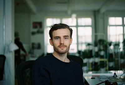 Portrait of young man in office