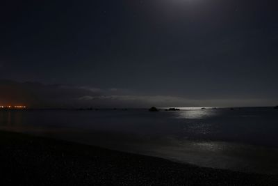 Scenic view of sea against sky at night