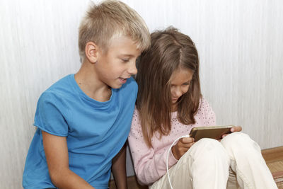 Boy sitting on mobile phone