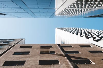 Low angle view of modern building against clear blue sky