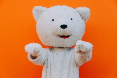 Close-up of stuffed toy against orange background