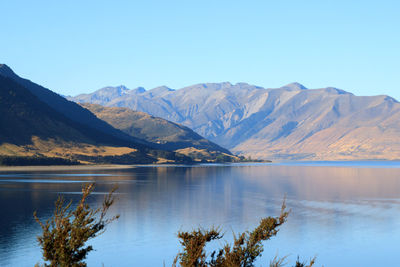 Scenic view of lake and mountains against sky