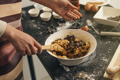 Midsection of person preparing food on table