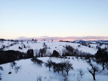 Scenic view of landscape against clear sky during winter