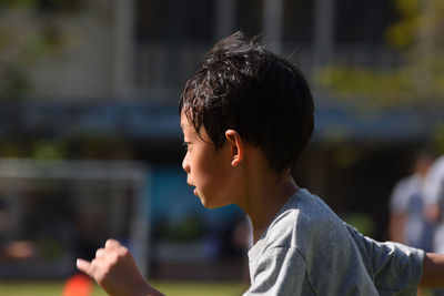 Close-up of boy running on street