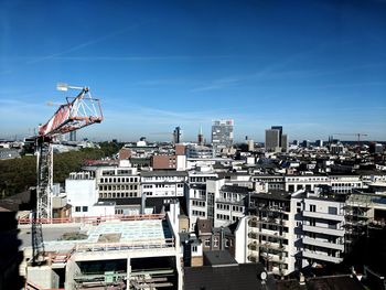 High angle view of buildings against blue sky