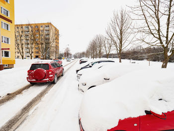 Snow covered car in city during winter