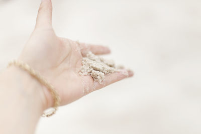 Womans hand holding sand