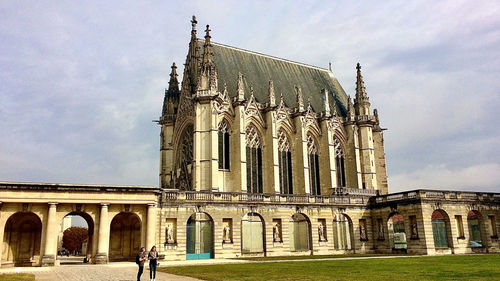 Facade of historic building against sky