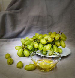 High angle view of grapes in glass bowl on table