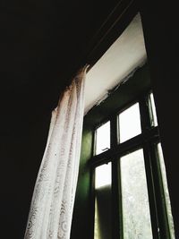 Low angle view of window in abandoned building