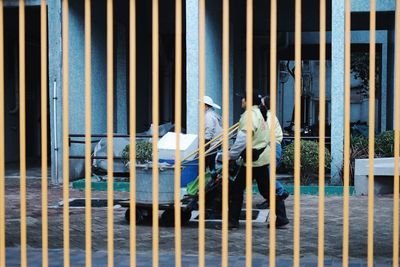 Workers with push cart on footpath