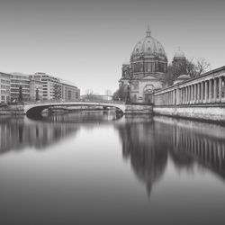 Reflection of dome in river against sky