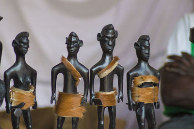 Close-up of carved wooden human toys