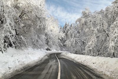 Road amidst trees against sky