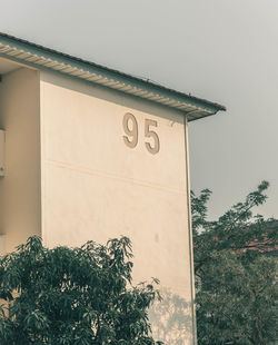 Low angle view of text on wall against building