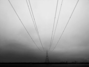 Low angle view of electricity pylon against sky
