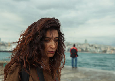 Woman looking away against sea and sky