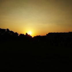 Silhouette landscape against clear sky during sunset