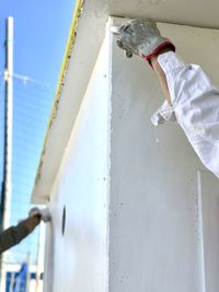 Low angle view of man working on wall